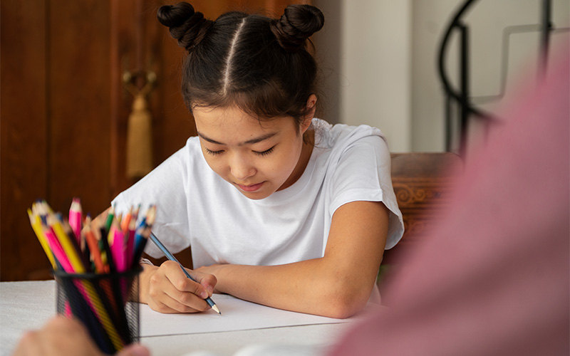 Young student focused on completing an English comprehension exam.