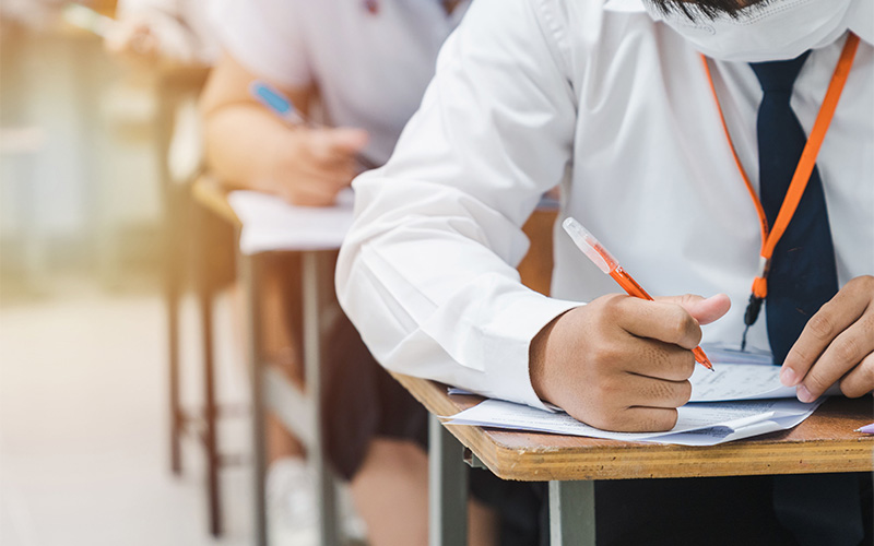 Student focusing on accuracy during PSLE English Grammar Cloze.